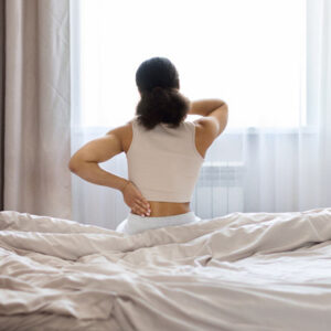 Why does back pain feel worse after waking up