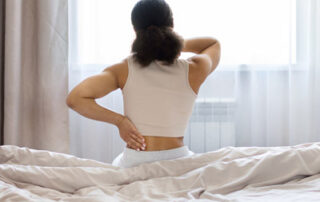 Why does back pain feel worse after waking up